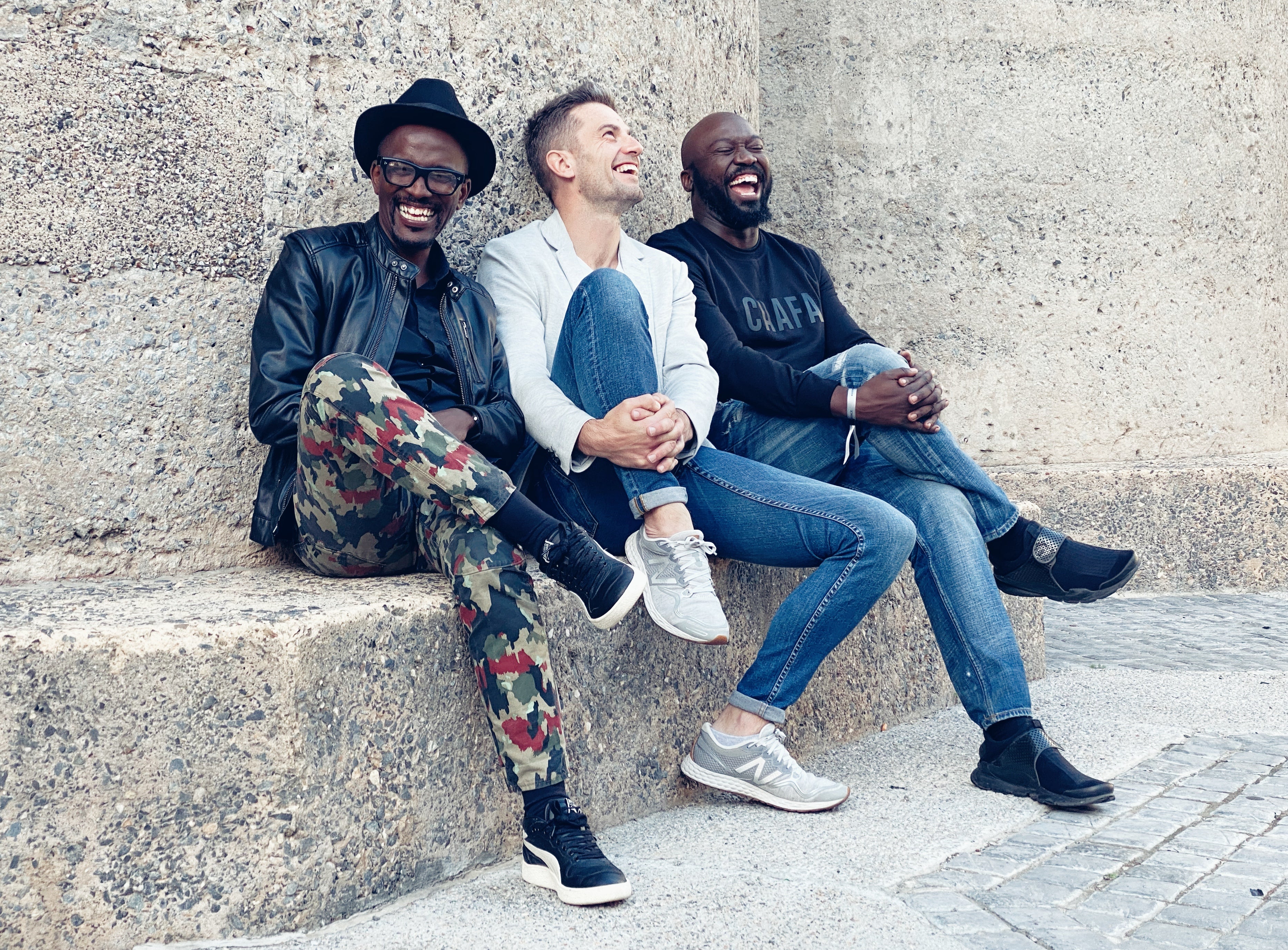 3 Men sitting on a rock